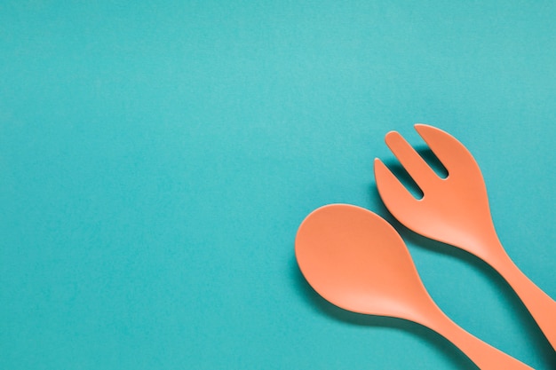 Free Photo spoon and fork on blue background 