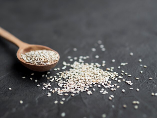 Spoon full of spices on black background