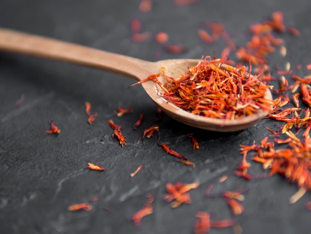 Free photo spoon full of spices on black background