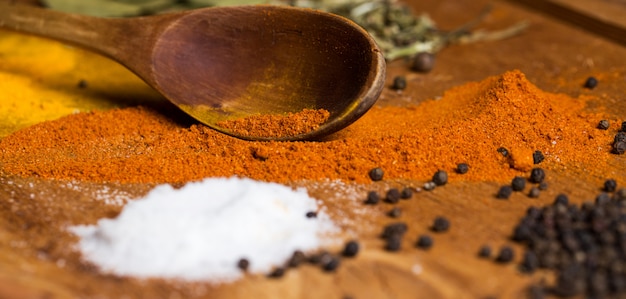 Free photo spoon and heap of spices on the table