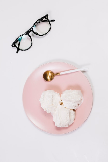 Spoon and ice cream on plate