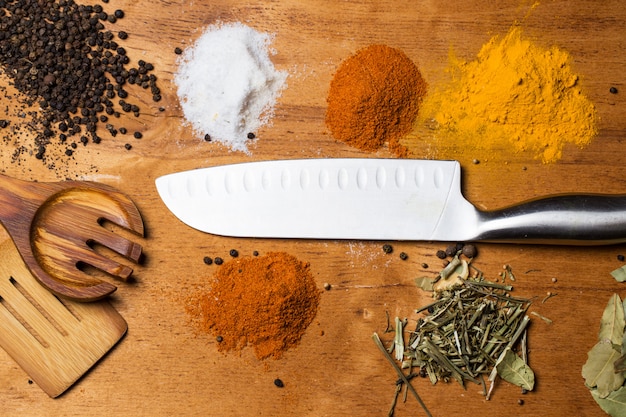 Free photo spoon, knife and heap of spices on the table