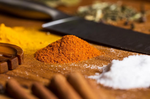 Free photo spoon, knife and heap of spices on the table