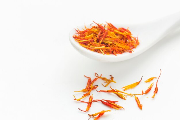 Spoon with flavored spices on table