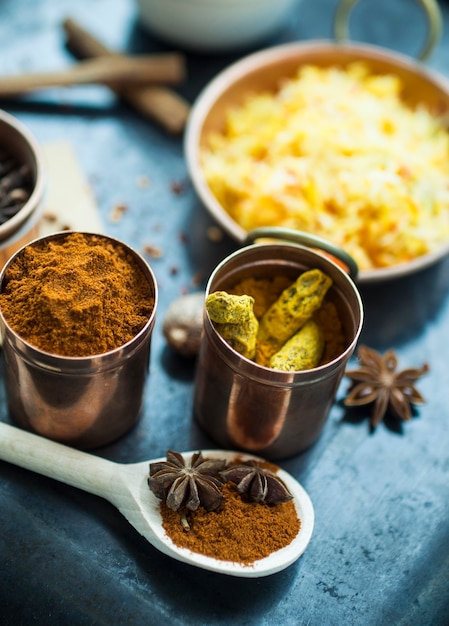 Free photo spoon with spices near tins and dish