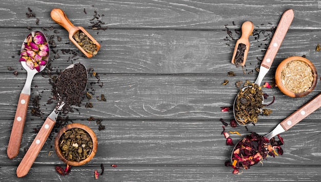 Spoons with herbal tea on desk