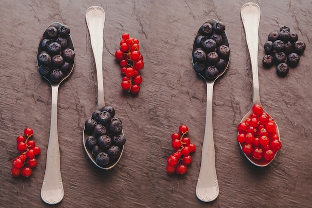 Free Photo spoons with red fruits