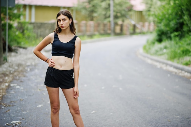 Sport girl at sportswear exercising in a green park and training at nature A healthy lifestyle