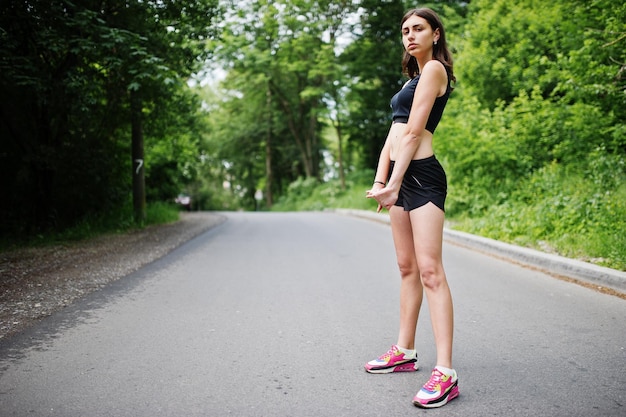 Sport girl at sportswear exercising in a green park and training at nature A healthy lifestyle