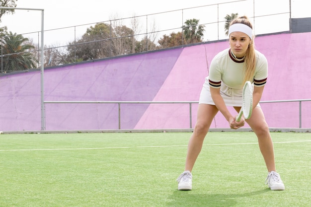 Sportive woman waiting to hit ball