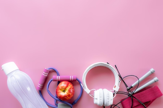 Sports equipment items on pink background flat lay