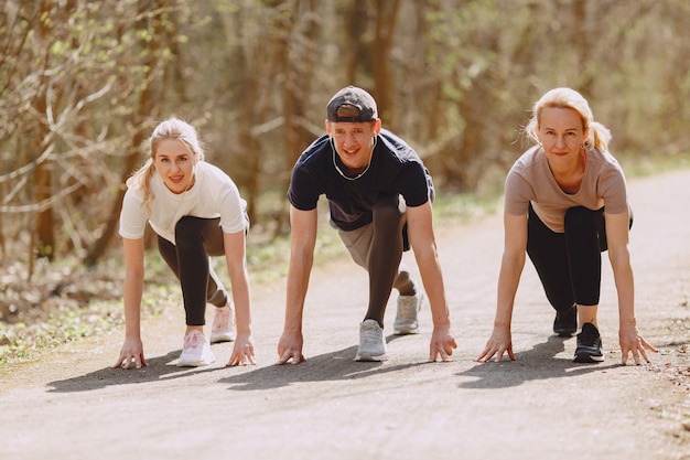 Free photo sports family training in a summer forest