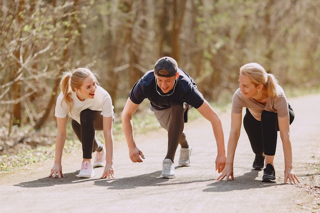 Free photo sports family training in a summer forest