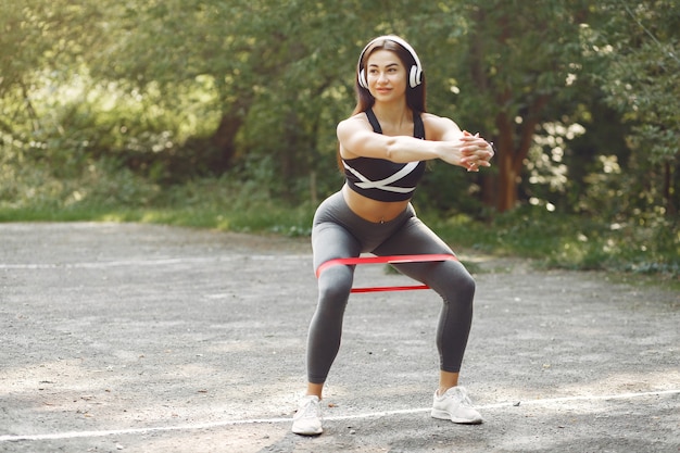 Sports girl training with sports elastic bands