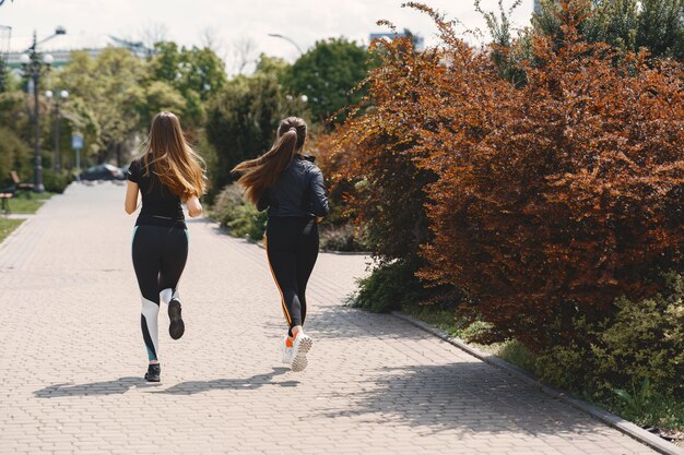 Sports girls training in a summer forest