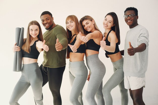 Sports group standing on a white wall