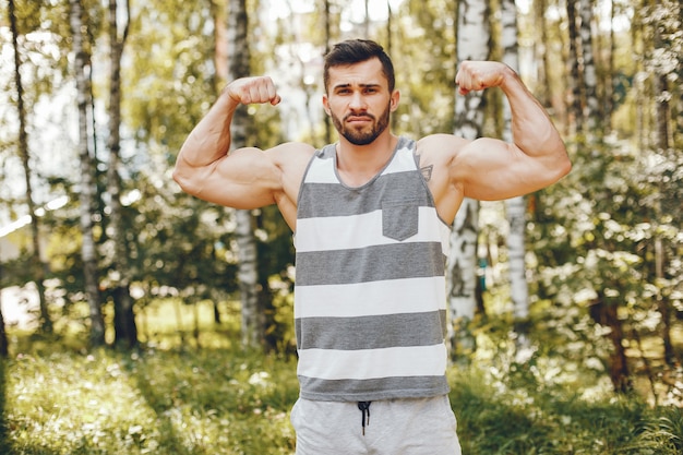 Sports man in a morning summer park 