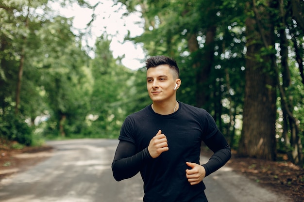 Sports man in a morning summer park