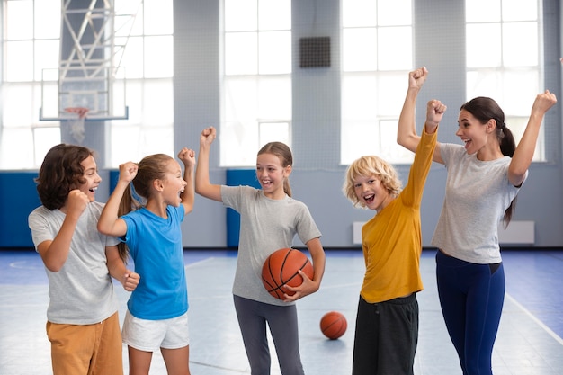 Free photo sports teacher with her students