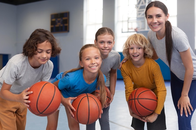 Free photo sports teacher with her students