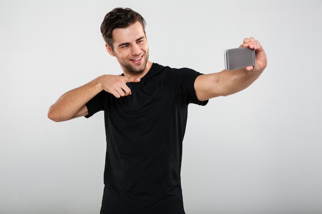 Sportsman make selfie by mobile phone pointing.