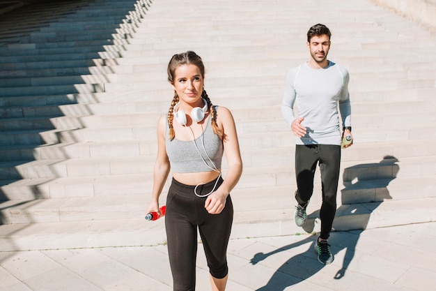 Free Photo sportspeople walking in sunlight on street