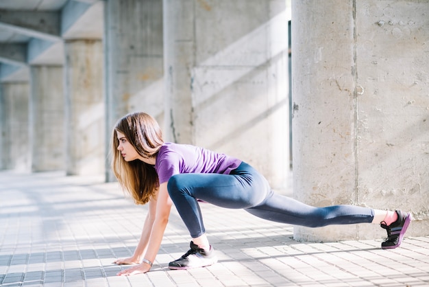 Free photo sportswoman doing stretching on the floor