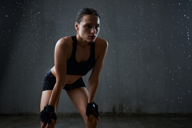 Free photo sportswoman posing in sportswear isolated on gray