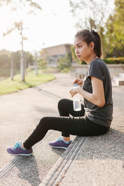 Sportswoman with water bottle on a sunny day