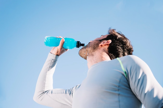 Sporty man drinking water