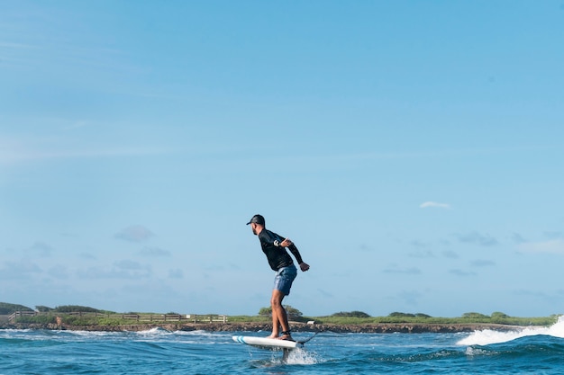 Sporty man surfing in hawaii