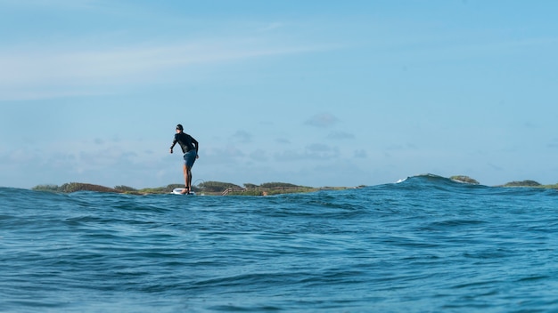 Sporty man surfing in hawaii