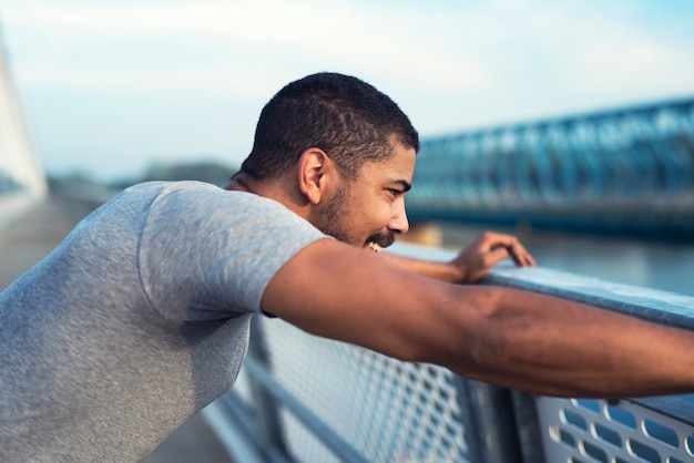 Free photo sporty man with smile on his face getting focused and ready for training