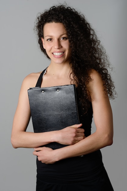 Sporty woman holding a clipboard