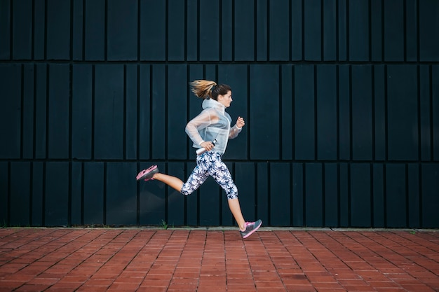 Sporty woman running in urban environment