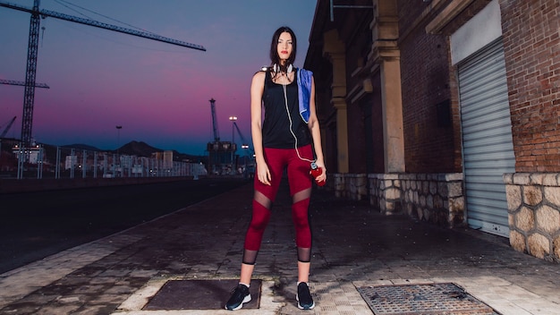 Free photo sporty woman standing on street