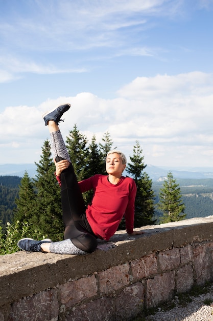 Sporty woman stretching in nature