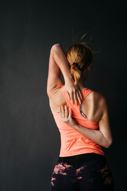 Sporty woman stretching in urban environment