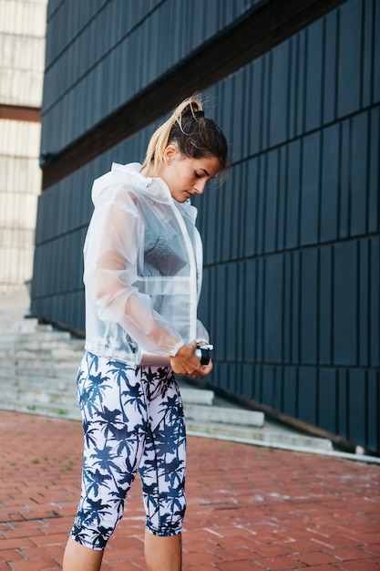 Free Photo sporty woman with rainjacket in urban environment