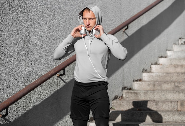 Sporty young man preparing his headphones