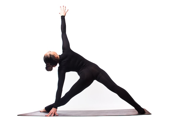 Sporty young woman doing yoga practice isolated on white background - concept of healthy life and natural balance between body and mental development