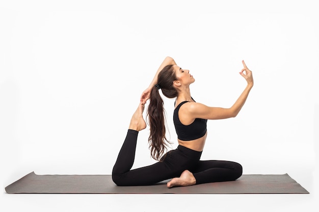 Free photo sporty young woman doing yoga practice isolated on white surface - concept of healthy life and natural balance between body and mental development