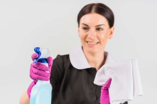 Free photo spray of detergent in hand of maid in uniform