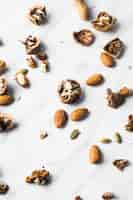 Free photo spread of dried fruits on white marble backdrop