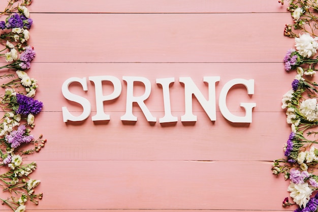 Spring word on table with flowers