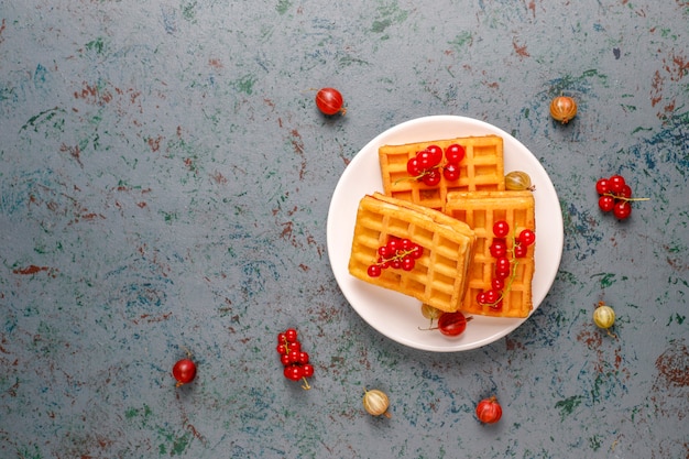 Free photo square belgian waffles with loquat fruits and honey