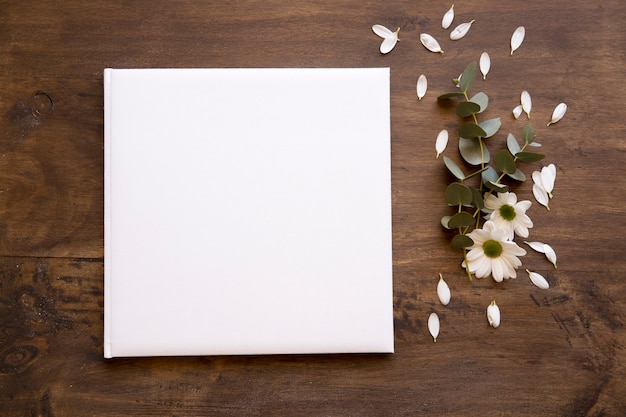 Free Photo square paper mockup with flowers