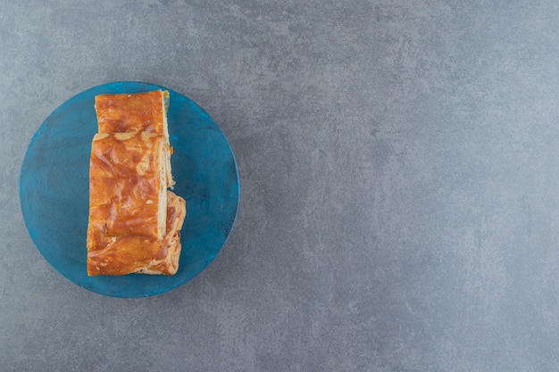 Free photo square shaped stuffed pastries on blue board.