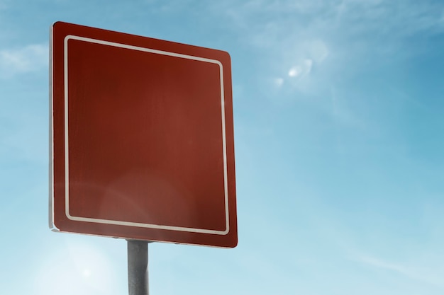 Square street sign under blue sky