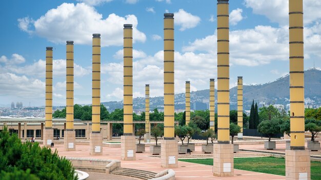 Square with greenery and columns, view of Barcelona on the background, Spain